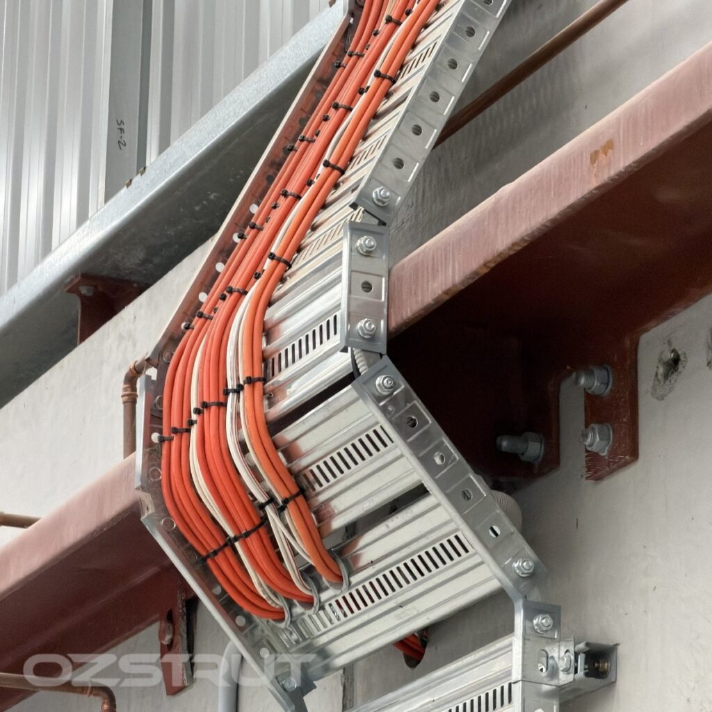 T3 cable tray with riser links routing cables around beam