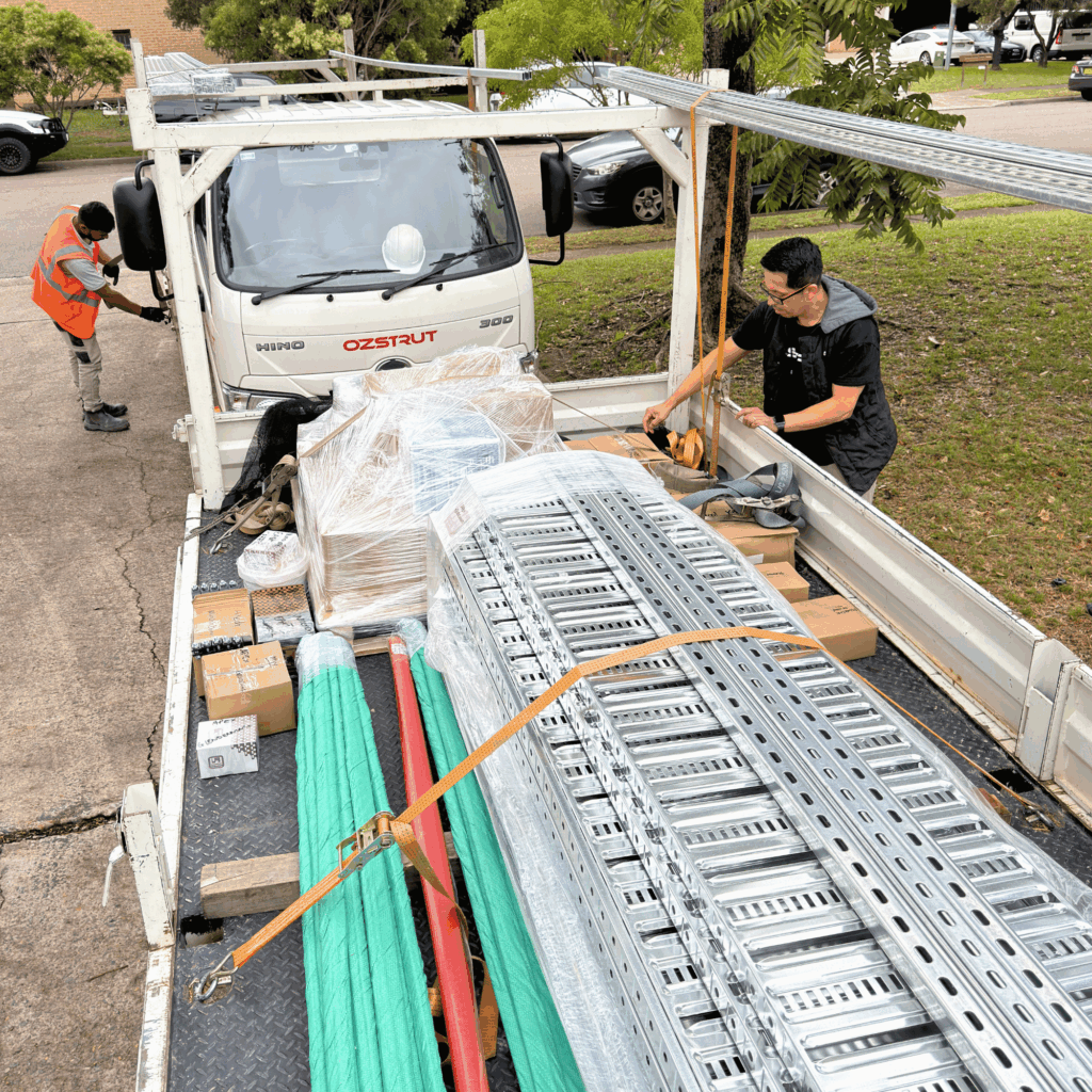 Loading construction supplies onto Ozstrut delivery truck Sydney